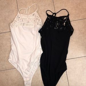 Black and white stretchy body suits with clasps